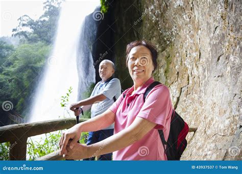 Asian Senior Couple Hiking in the Mountain with Waterfall Stock Image - Image of asia, enjoying ...