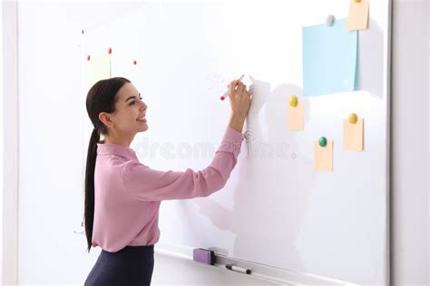 Teacher Writing On Whiteboard In Classroom Stock Photo Image Of