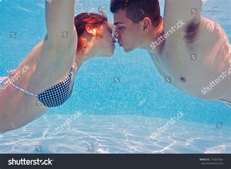 Underwater Couple Kissing In Swimming Pool Stock Photo