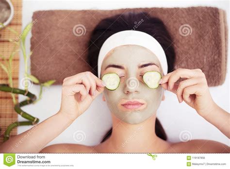 Beautiful Young Woman Is Getting Facial Clay Mask At Spa Lying Stock