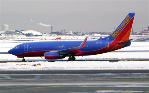 Southwest Airlines Plane With Snow Background Photograph By Bob Dashman