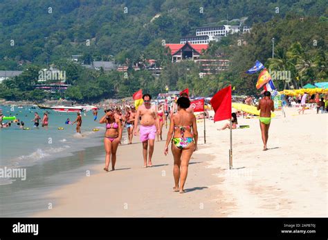 People enjoy the seashore at Patong Beach, Phuket, Thailand, Asia, on a ...