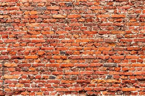 Brick Wall Made Of Old Crumbling Red Bricks Falling Out Stock Photo