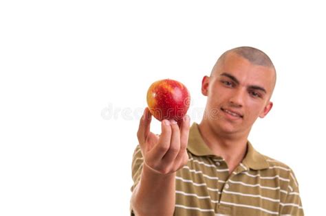 Closeup Portrait Of A Healthy Young Man Holding And Offering An Apple