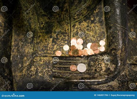 Sitting Buddha Statue With A Merit Coin Money On The Buddha`s Hand At