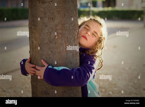 Girl Hugging A Tree Stock Photo Alamy