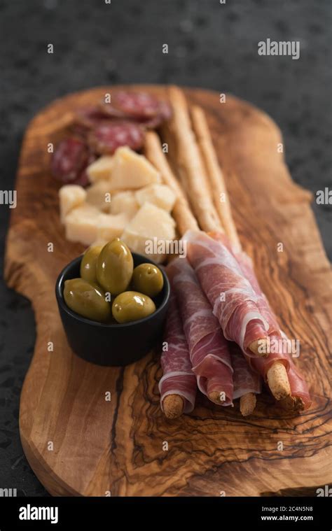 Italian Snacks On Olive Wood Board Stock Photo Alamy