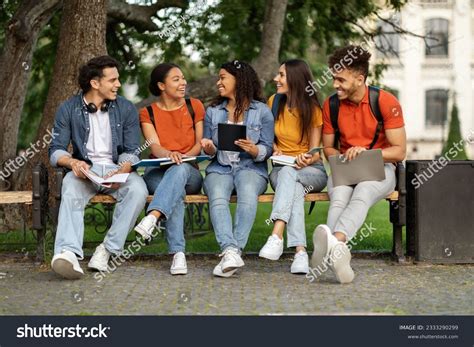 College Students Sitting On Bench