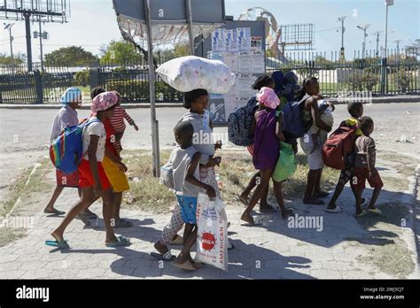 People Flee Their Homes In Cite Soleil Due To Gang Violence As They Walk To A Police Station In