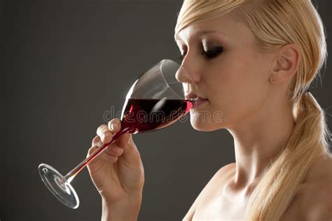 Woman With Beautiful Red Hair Is Drinking A Glass Of Red Wine Stock