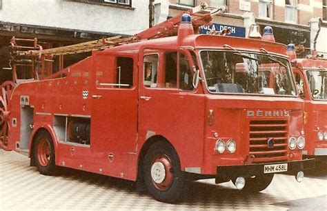 Two Red Fire Trucks Parked Next To Each Other