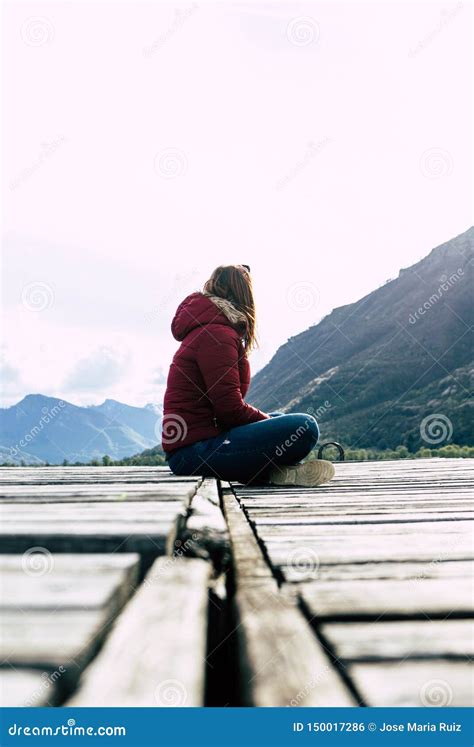 Alone Women Relax on Wooden Dock at Peaceful Lake. Girl Meditation with Red Jacket in a Wood ...