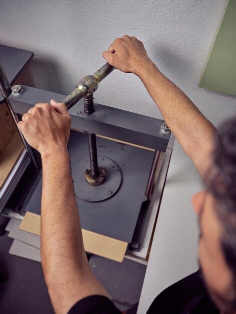 Premium Photo High Angle Of Crop Anonymous Male Worker Using Machine