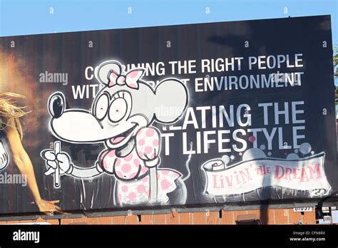 British Graffiti Artist Banksy Hits A Hollywood Billboard With A Stock