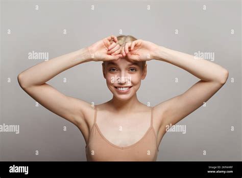 Close Up Of Young Woman Holding Her Arms Up And Showing Her Armpit On