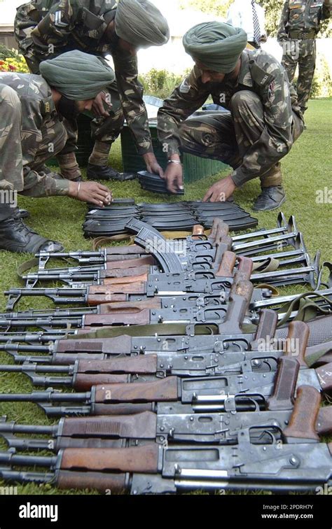 An Indian Army Soldiers Look At Seized Arms And Ammunition During A