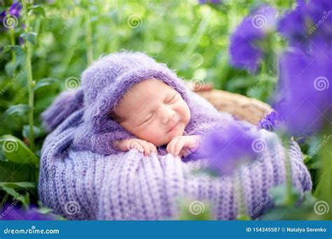 17 Day Old Smiling Newborn Baby Is Sleeping On His Stomach In The