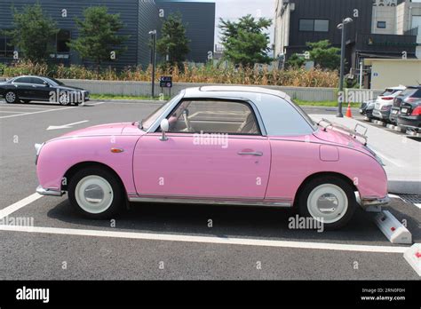 Side View Of Vintage Pink Car In Parking Lot Stock Photo Alamy