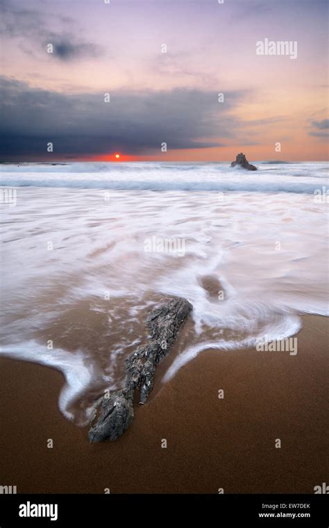 Rocks With Silky Water In Sopelana Beach At Sunset Stock Photo Alamy