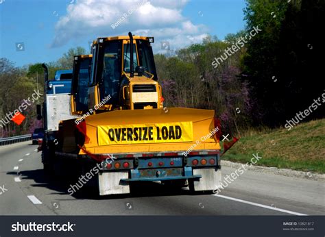 Oversize Load Of Bulldozer Is Loaded On A Flatbed Trailer Being Pulled