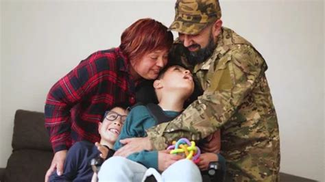 Veteran soldier hugging his family after... | Stock Video | Pond5