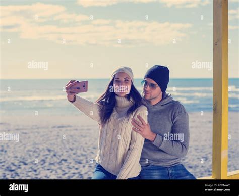 Very Happy Couple In Love Taking Selfie On The Beach In Autmun Day