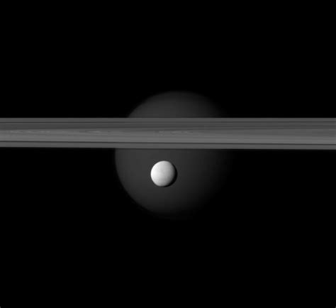 Saturn’s two most charismatic moons, Titan and Enceladus, photographed together against the ring ...