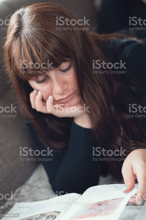 Portrait Of Woman Lying Down Reading A Book Stock Photo Download