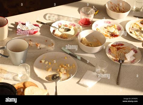 Empty dirty plates with spoons and forks on the table after meal ...