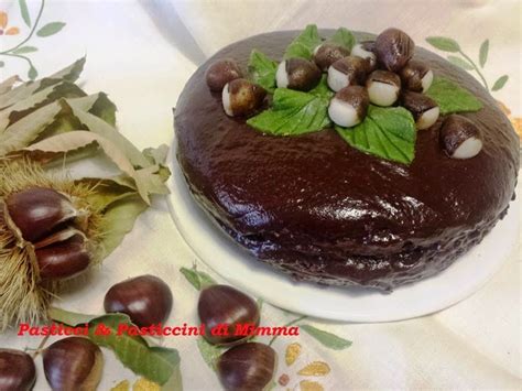 A Chocolate Cake Sitting On Top Of A White Plate Next To Leaves And Acorns