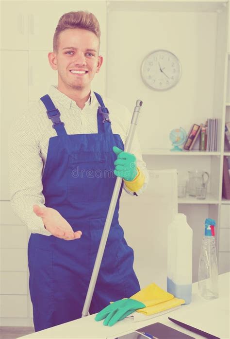 Guy In Uniform Cleaning In Office Stock Photo Image Of Supplies