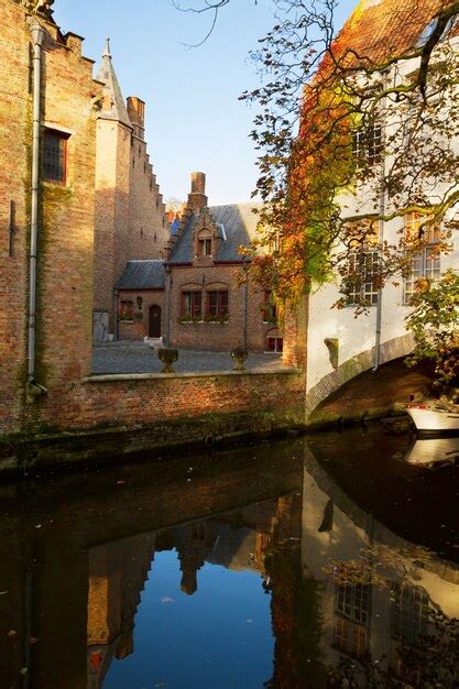 Premium Photo Small Street Of Old Bruges With Canal Belgium