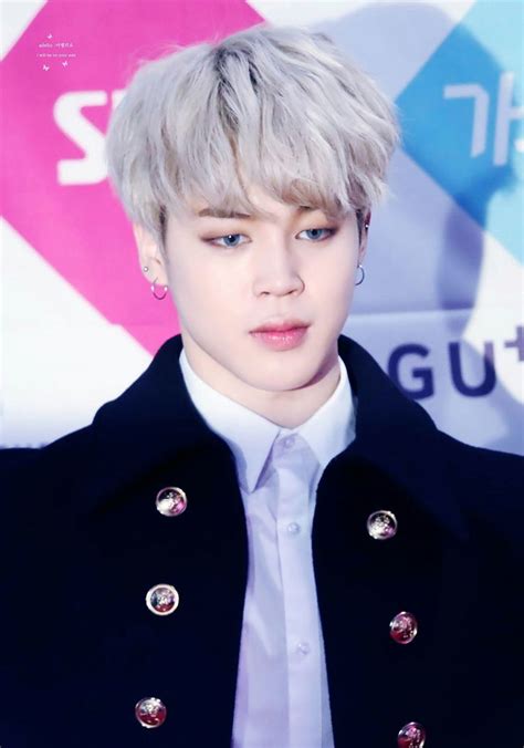 A Male In A White Shirt And Black Jacket With Buttons On His Lapel Coat