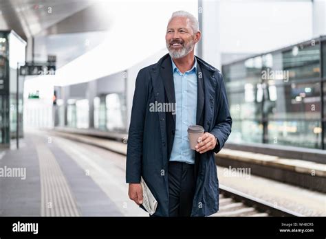Smiling Mature Businessman At The Station Platform Stock Photo Alamy