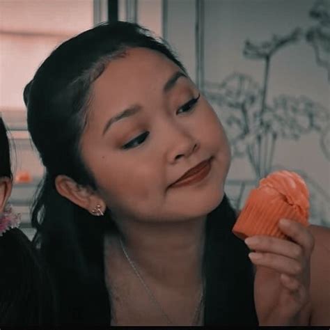 Two Women Are Eating An Orange Pastry Together