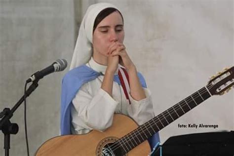 A Woman With A White Veil On Her Head Is Playing An Acoustic Guitar