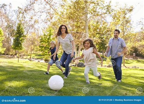 Family Playing Soccer in Park Together Stock Photo - Image of enjoyment ...