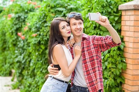 Premium Photo Happy Beautiful Couple Taking A Selfie On A Mobile