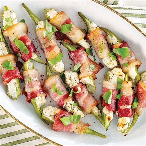 A White Plate Topped With Green Beans And Bacon Wrapped In Bacon On Skewers