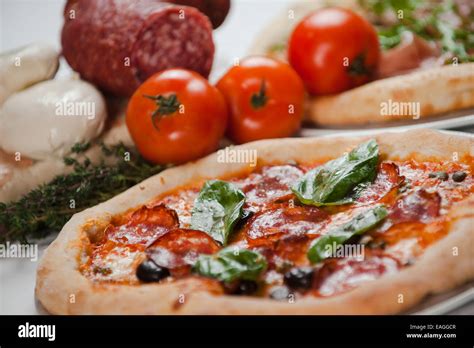 Italian Pizza With Salami Rocket And Basil Stock Photo Alamy