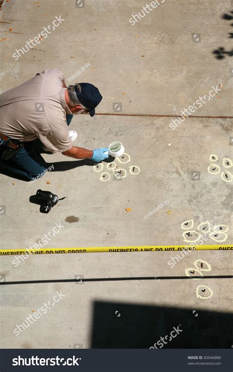 A Crime Scene Investigator Gathers Evidence At The Scene Of A Crime ...