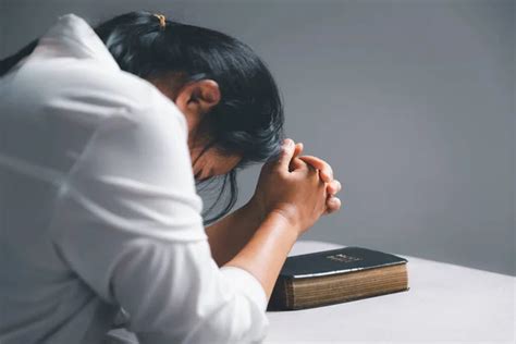 Woman Kneeling And Praying In Modern House At Sunset Time Female