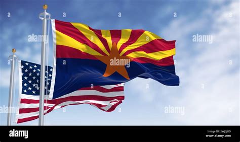 Flags Of Arizona And United States Waving In The Wind On A Clear Day