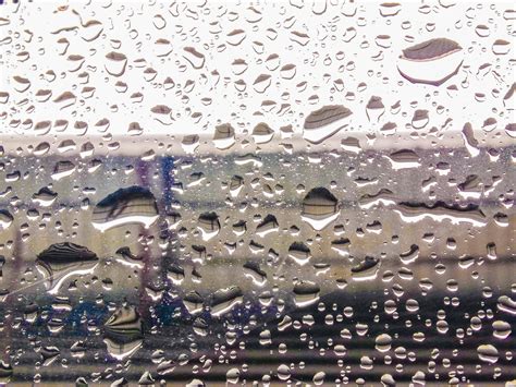 Raindrops on blurred glass background, rainy season concept, weather