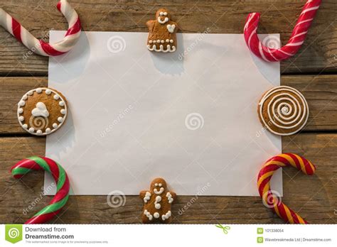 Overhead View Of Candy Canes With Gingerbread Cookies And Paper