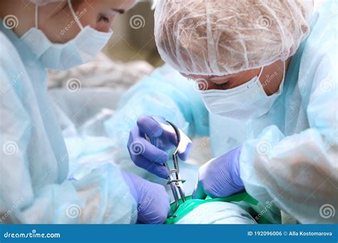 Pediatric Dentist And Assistant During Surgery Under General Anesthesia