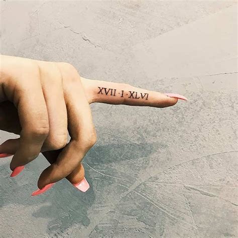 Roman Numerals Tattoo Finger