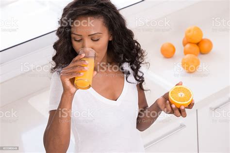 Woman Drinking Fresh Orange Juice At Kitchen Stock Photo Download