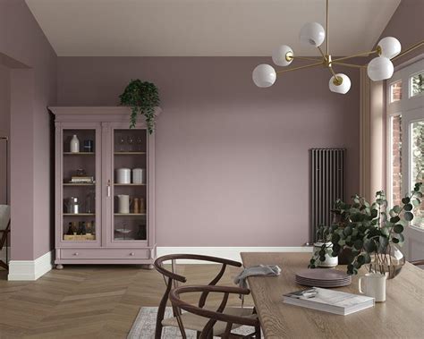 A Dining Room With Orange Walls And Wooden Floors