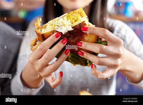 Young Woman Eating Fast Food Mid Section Close Up Stock Photo Alamy